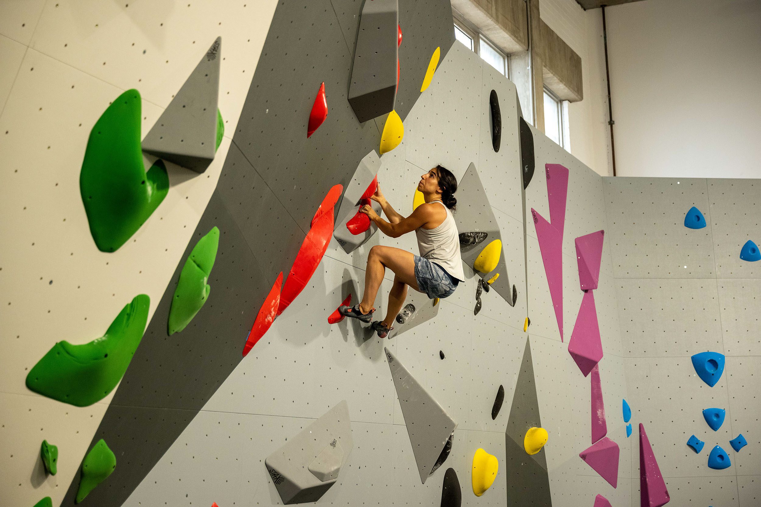 woman climbing bouldering wall